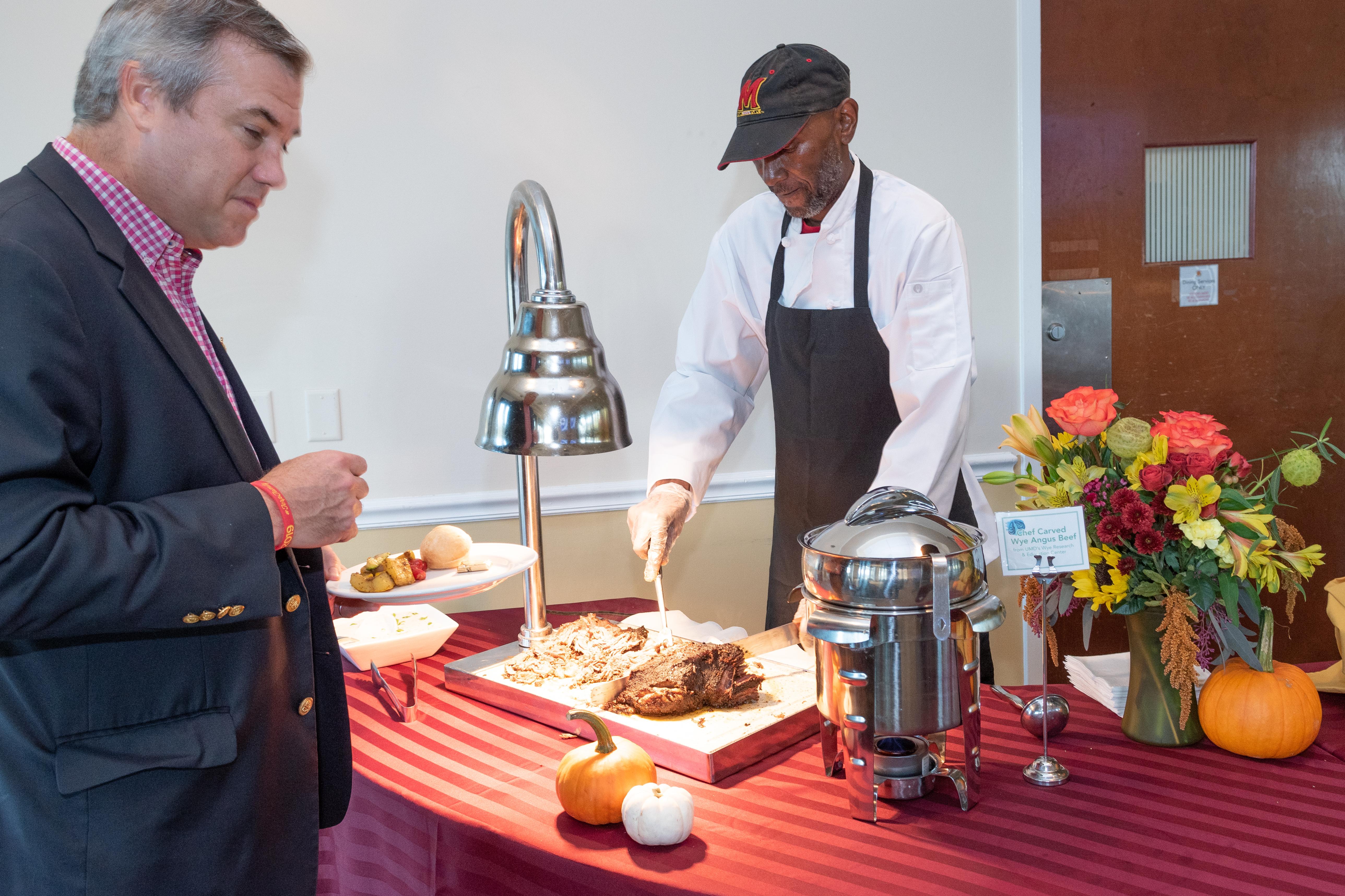 A person serving food to another person