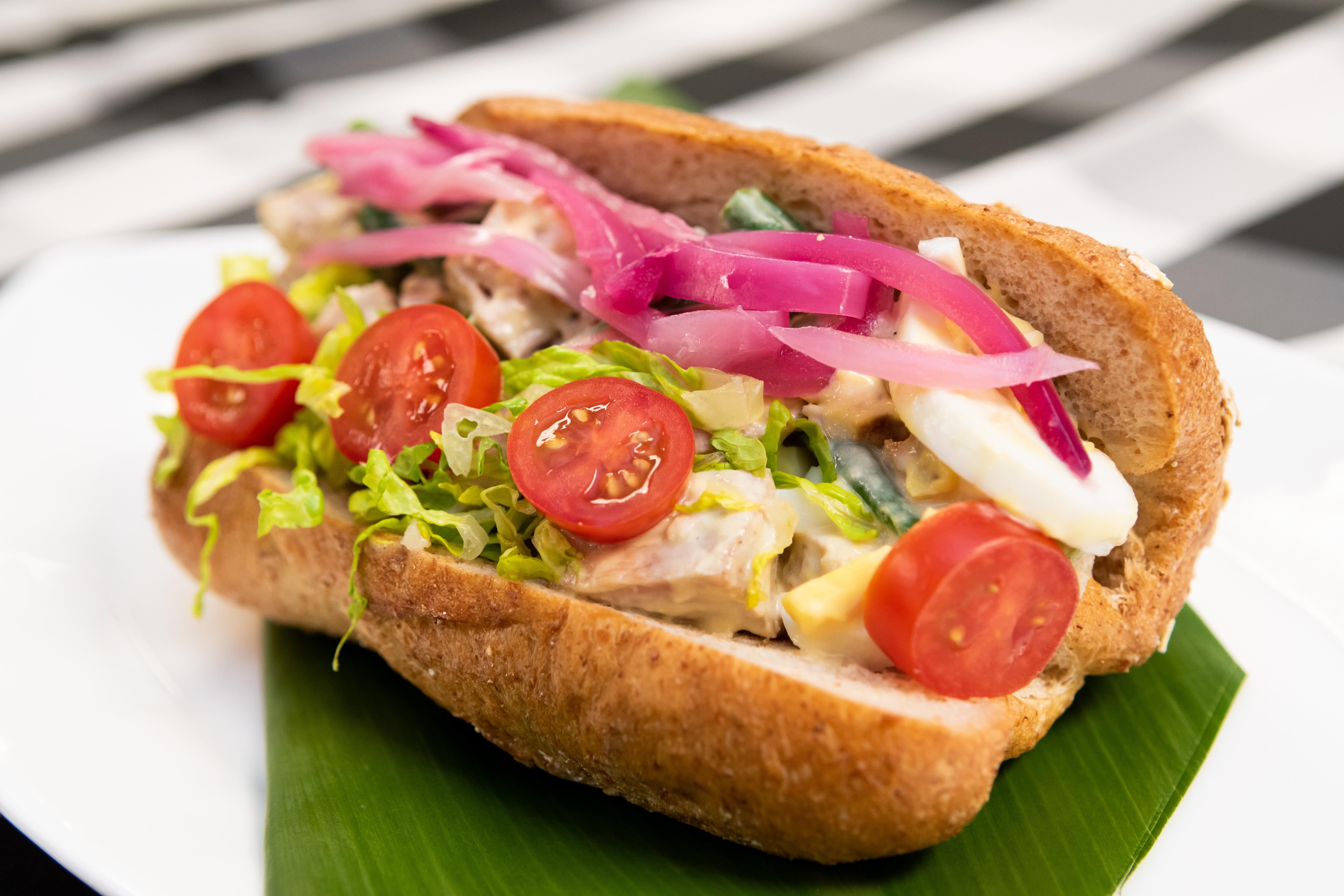 A sandwich made of tomatoes, onions, lettuce and other ingredients.