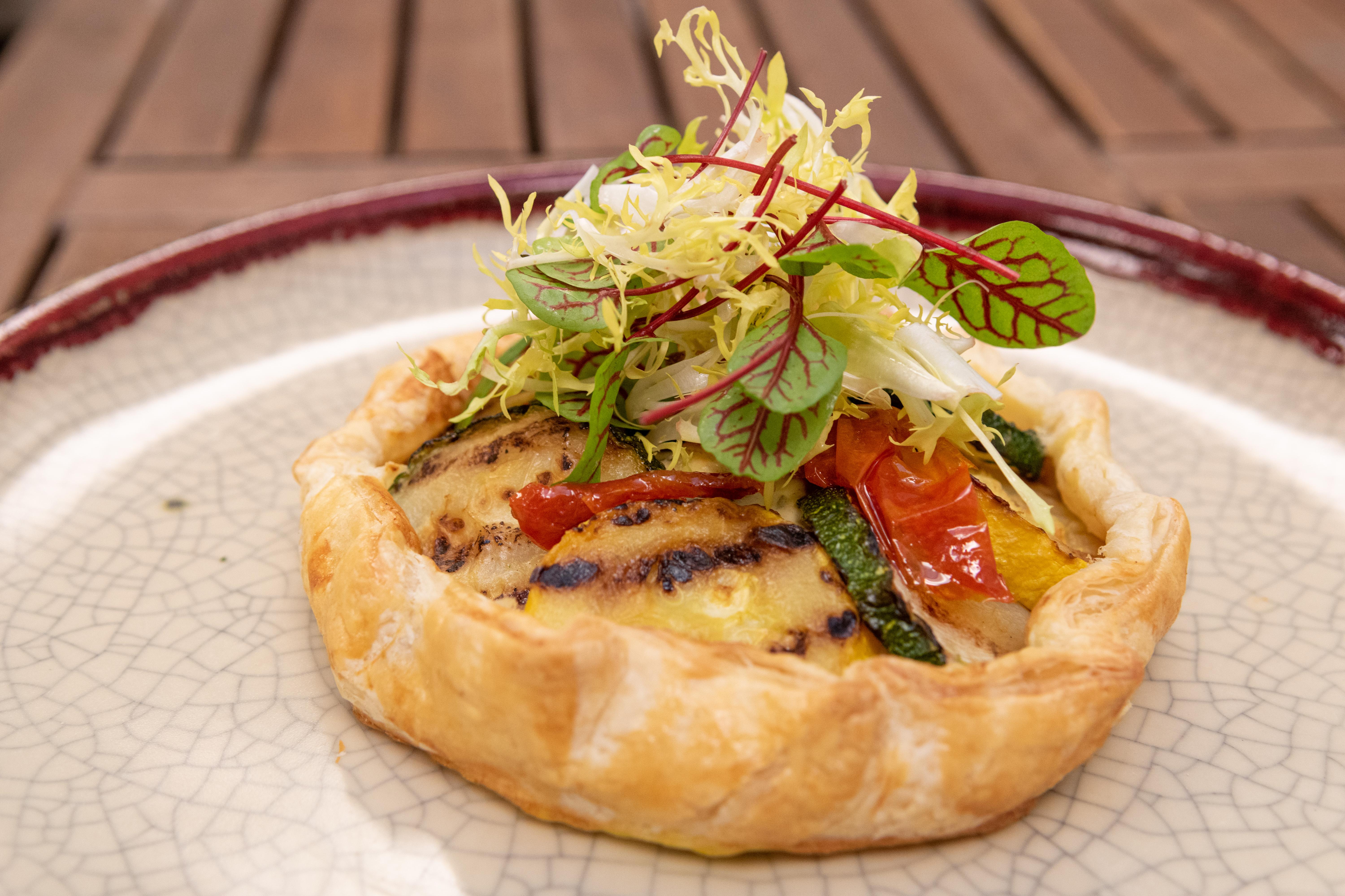 A circular dish made of bread with different toppings