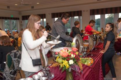 people getting food at an event